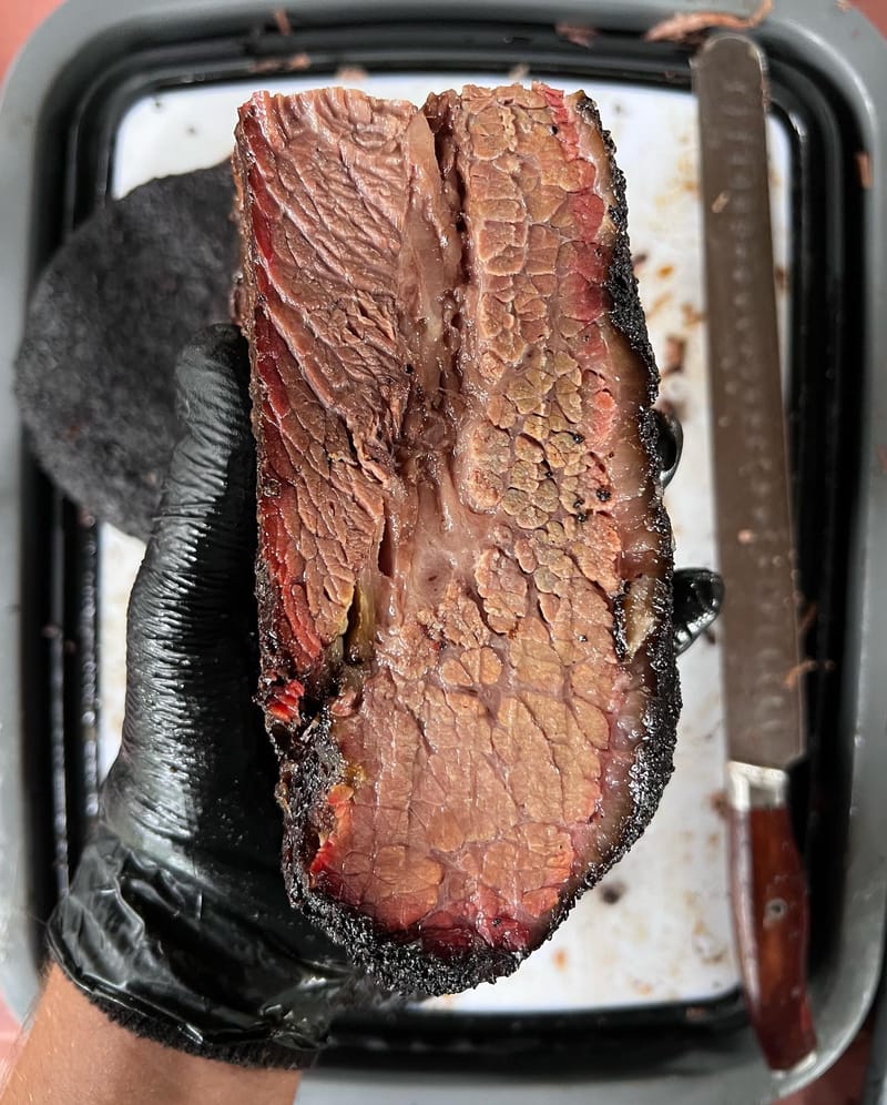 Cross section of a brisket smoked on a Weber Smokey Mountain with charcoal and wood. This was a choice brisket, but turned…