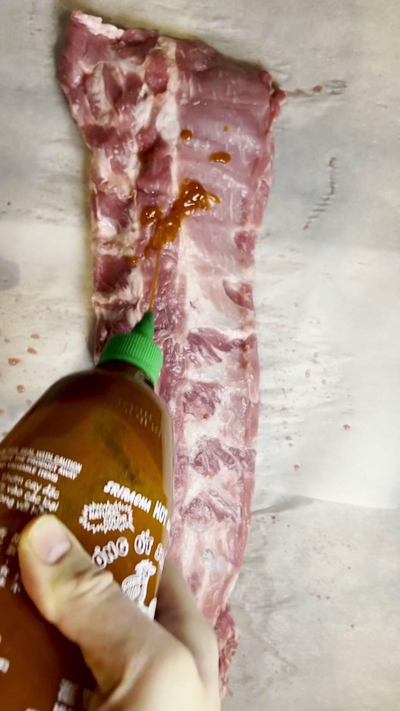 Ribs with a kick sriracha ribs #bbq #learnontiktok #smokedmeat #spicy #sriracha #fyp #meat #howto #food #pork #ribs…