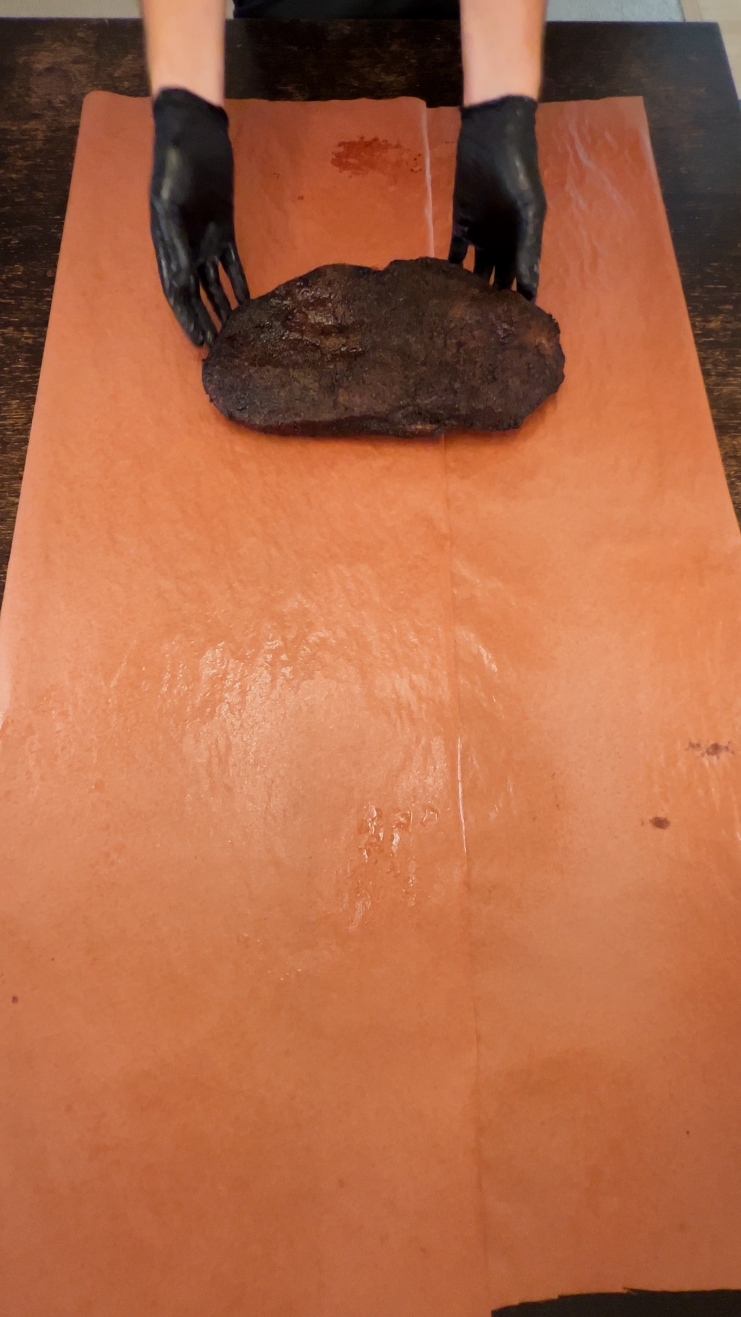 Placing brisket on paper