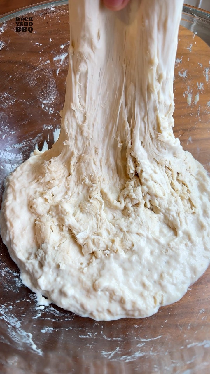 Stretch & Fold 
The whole point of no knead bread is it doesn’t require a lot of hands on time and even Jim Lahey says to leave it alone for 12-18 hours after the initial mix. 

But I personally like to give it a stretch and fold about 30 minutes into the first proof. I’ve found that it helps build better gluten, which means a better crumb, and the crust seems to be more consistent as well. 

With a damp hand, pick up one side as far as it will go before it tears, then fold it towards the middle. Turn the bowl and repeat.  Go around a few times until you have a consistent smooth surface.  I like to do a couple of slap and folds as well to help shape it into a ball.  You could do a few more rounds of stretch and folds every 30 minutes, but I only do it once.

When you’re done, put the cover back on and back on the counter to continue proofing.

See my Busy People Bread video for the whole recipe.

#bread #nokneadbread #breadtips