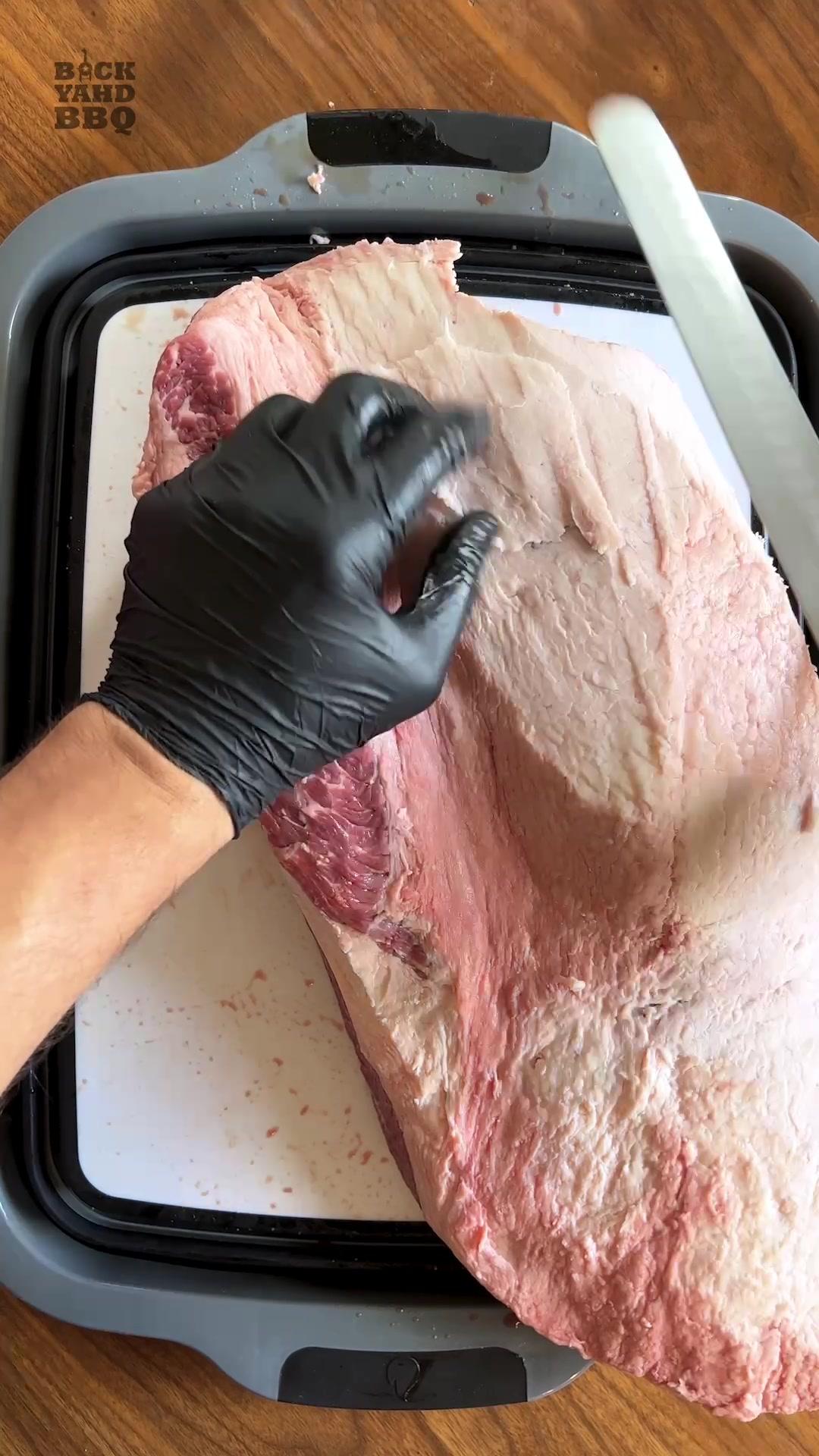 When I was first learning how to trim a brisket I stressed pretty hard about not gouging into the fat cap.  I’m here to tell you that I’ve done it and I’ve survived and it’s okay.  Exposing a little of the meat through the fat cap isn’t the end of the world and the brisket will still be fantastic. In fact, some briskets come with meat exposed and there’s nothing you can do about it and it still turns out great. Your goal should be to trim the fat cap down to about a quarter of an inch all the way around.  Sometimes that means putting your knife in awkward positions.  It helps to learn what a quarter inch of fat feels like - so once you get a section down to a quarter of an inch, push on the fat to get a sense for it.   As you are trimming, feel and look around for anything that looks more than a quarter of an inch.  Trim a little, then lift the fat, look under the knife, gauge the thickness, and keep cutting. When you’ve accidentally cut into the meat, and you will, you can either back out and cover it up or finish the cut and leave it exposed.  I personally like to continue cutting because aesthetically I don’t want a piece of flappy fat left on top of my meat. Everything about bbq should be enjoyable, including brisket trimming, so go into it without stress and just move on if you make mistake.   Music by @ianmullmusic amazing guitar work on his channel. Check him out!  #gifted #affiliate #bbq #bbqtips #brisket #briskettrim #howto #learnontiktok #smokedmeat #smokedbrisket #brisketprep @backyahdbbq  @backyahdbbq @backyahdbbq 